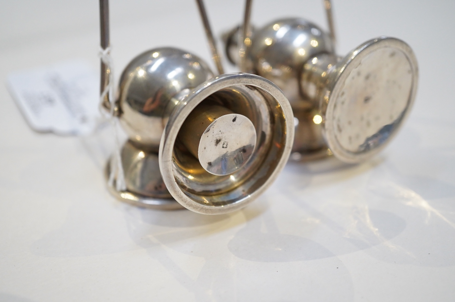 An Edwardian novelty cigar cutter and perpetual lighter, modelled as a pair of railway lamps, by Walker & Hall
